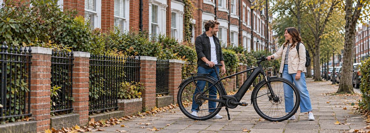 A seller handing over a black electric bike on a residential street